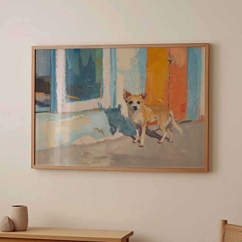 May include: A framed painting depicting a small, light brown dog standing in front of a colourful building with a blue door and a yellow wall. The dog is looking directly at the viewer.