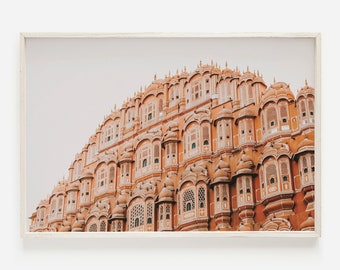 May include: A close-up view of the Hawa Mahal, a palace in Jaipur, India. The palace is made of pink sandstone and has many intricate windows and balconies. The palace is a popular tourist destination and is known for its unique architecture.