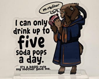 May include: A clear acrylic standee featuring a brown goat wearing a dark blue robe and holding a pink soda can. The text reads: I can only drink up to five soda pops a day. It's a HARD rule my mother gave me. A speech bubble says: m-mother.