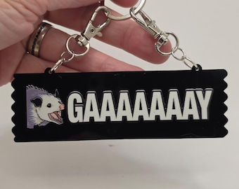 4" acrylic Gaaaaaaay Pride Possum Ribbon Keeper keychain for badge ribbons - sdcc eccc nycc collector pride month LGBTQIA+