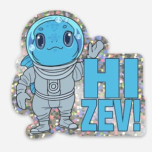 May include: A sticker featuring a blue cartoon character in a spacesuit with a bubble helmet. The character is waving, and the words "HI ZEV!" are in blue block letters. The sticker has a glittery, iridescent border.