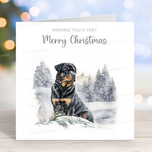 Tarjeta navideña de rottweiler, encantadora tarjeta de felicitación navideña con un perro, divertida escena de nieve invernal, 15 x 15 cm, interior en blanco.