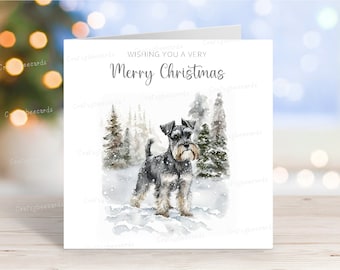 May include: A Christmas card featuring a watercolor illustration of a miniature schnauzer dog standing in a snowy forest. The card has the text "Wishing you a very Merry Christmas" printed on it.