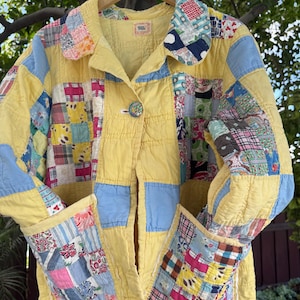 May include: A vintage patchwork jacket in yellow, blue, and various patterned fabrics. The jacket features a button closure, two pockets, and a collar. The patchwork design includes squares and rectangles of different colors and patterns, creating a unique and colorful garment.