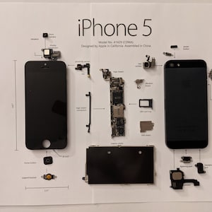 May include: A disassembled iPhone 5, model number A1429 (CDMA), designed by Apple in California and assembled in China. The phone is laid out on a white surface with all of its components, including the logic board, camera, display, and battery.