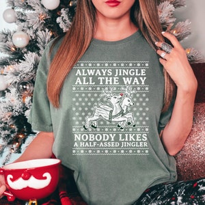 May include: Green Christmas themed t-shirt with a white reindeer graphic and the text "Always Jingle All The Way" and "Nobody Likes A Half-Assed Jingler".