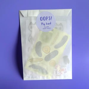 May include: A white envelope with a sticker that says "OOPS! My bad 6 grade sticker sheets." The envelope contains a sheet of stickers with various shapes and designs.