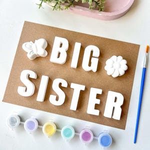 May include: A distressed wooden sign, inscribed with 'Welcome to our home' in white lettering. The sign has a rustic finish, ideal for a porch or hallway, creating a welcoming atmosphere.