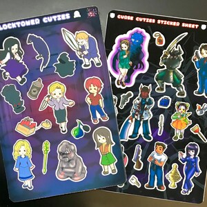 May include: Two sticker sheets with cartoon characters. One sheet is labelled "CLOCKTOWER CUTIES" and the other "CURSE CUTIES STICKER SHEET". The stickers depict various characters in different poses, with weapons and accessories. The background is a dark purple and black.