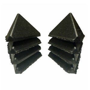 May include: A stack of six black foam corner protectors, with a pyramid shape, are arranged in a symmetrical pattern.