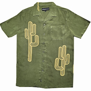 May include: A green short-sleeved button-up shirt with a yellow cactus design. The shirt has a collar and a pocket on the left side.