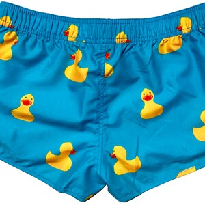 May include: Blue swim shorts with a pattern of yellow rubber ducks.