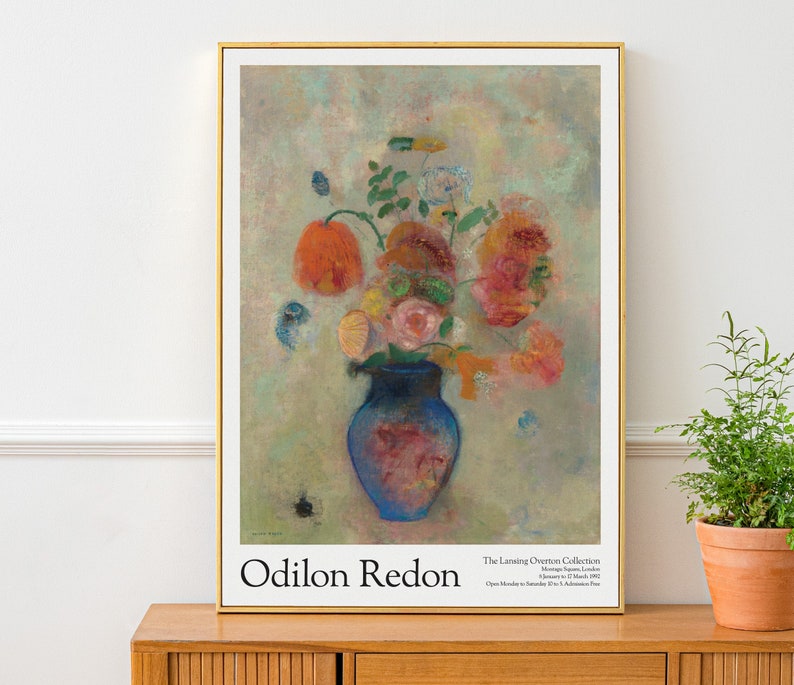May include: A painting of a vase of flowers by Odilon Redon. The vase is blue and the flowers are red, pink, and yellow. The background is a soft, pastel green.
