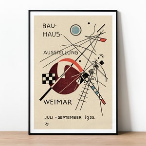 May include: A black and white poster with geometric shapes and lines. The poster has the text "BAU-HAUS-AUSSTELLUNG WEIMAR JULI - SEPTEMBER 1923." in black and white.
