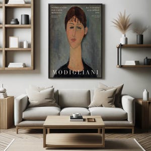 May include: A black and white poster featuring a portrait of a woman with long, dark hair and a long neck. The poster has the text "MODIGLIANI" at the bottom and "NUOVO CENTRO PER L'ARTE MODERNA" at the top.