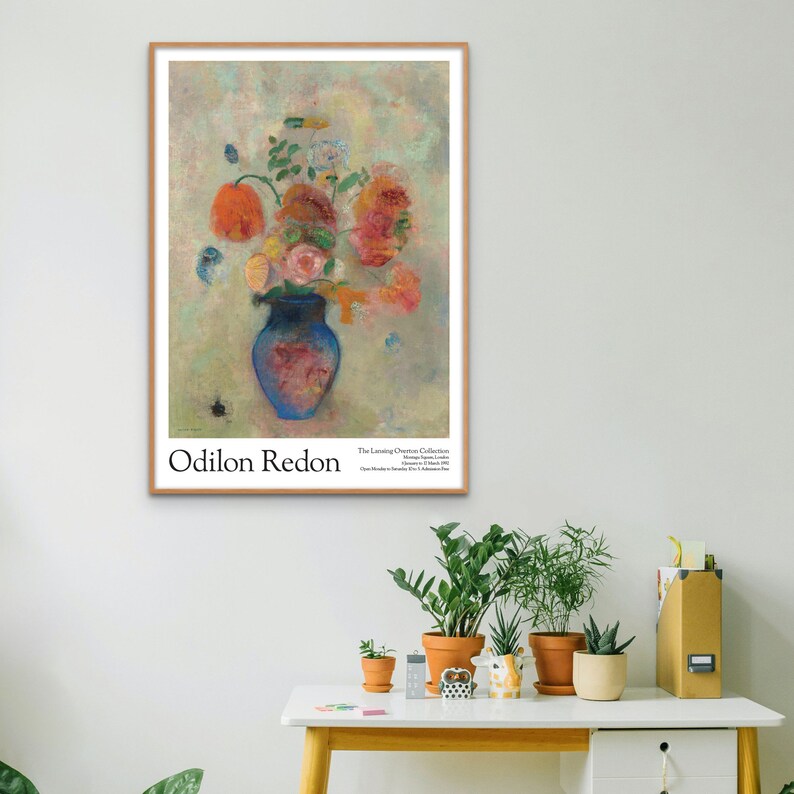 May include: A vintage poster featuring a still life painting of a blue vase filled with pink, red, and orange flowers. The artist's name, Odilon Redon, is printed at the bottom of the poster, along with the title of the painting, "The Lessing J. Rosenwald Collection".