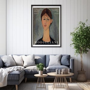 May include: A framed poster with a painting of a woman's face. The painting is in a style reminiscent of Amedeo Modigliani. The poster is titled "MODIGLIANI" and includes the text "NUOVO CENTRO PER L'ARTE MODERNA" and "Dal 19 Marzo al 22 Aprile 1950".