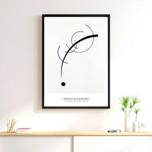 May include: Black and white abstract art print featuring a black curved line and a black circle on a white background. The print is framed in a black frame and has the artist's name, Wassily Kandinsky, printed below the image.