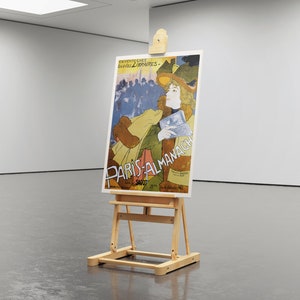 May include: A vintage poster on an easel advertising "Paris-Almanach" with a woman in a hat and a colorful background.