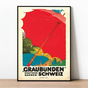 Puede incluir: Póster de viaje vintage que anuncia "Graubünden" Rhaetische Bahnen: Schweiz. El póster presenta un gran paraguas rojo con un mango de madera, un paisaje verde y azul y una pequeña figura en el fondo.