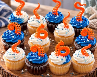 May include: A collection of twelve cupcakes arranged on a wooden board, featuring white and blue frosting topped with orange octopus tentacle decorations. Each cupcake is finished with small white and blue sprinkles scattered across the frosting.