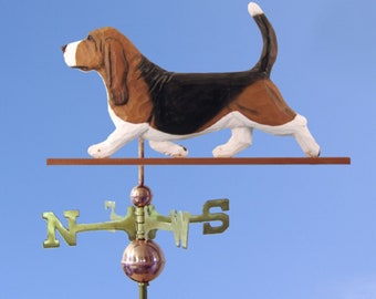 May include: A wooden basset hound weathervane with a brown, black, and white painted finish. The weathervane is mounted on a wooden rod with a compass rose.