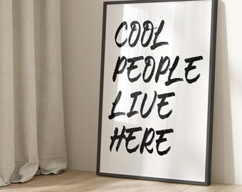 May include: Black and white framed print with the text "COOL PEOPLE LIVE HERE" in a bold, handwritten style.
