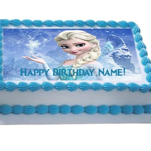 May include: A white cake with blue frosting and a printed image of Elsa from the movie Frozen. The image says "Happy Birthday Name!"