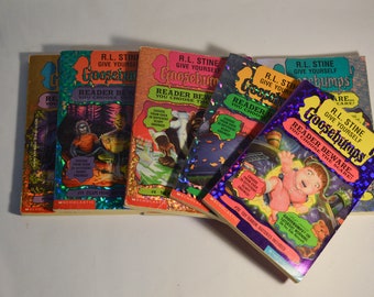 May include: A stack of Goosebumps books by R.L. Stine. The books have colorful covers with spooky illustrations and the text "Give Yourself Goosebumps" and "Reader Beware... You Choose The Scare!"