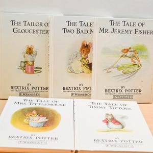 May include: Five vintage Beatrix Potter books are displayed, including "The Tailor of Gloucester," "The Tale of Two Bad Mice," and "The Tale of Mr. Jeremy Fisher." The books have illustrations and are from the original and authorised edition.