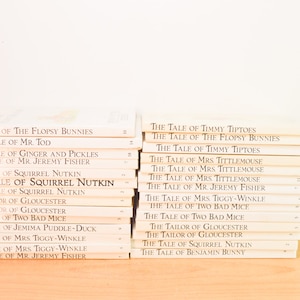May include: A stack of 29 paperback books with white covers and black text. The titles of the books are all from the "The Tale of" series by Beatrix Potter. The titles include "The Tale of the Flopsy Bunnies", "The Tale of Mr. Tod", "The Tale of Ginger and Pickles", "The Tale of Mr. Jeremy Fisher", "The Tale of Squirrel Nutkin", "The Tailor of Gloucester", "The Tale of Two Bad Mice", "The Tale of Jemima Puddle-Duck", "The Tale of Mrs. Tiggy-Winkle", and "The Tale of Timmy Tiptoes".