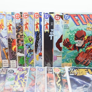 May include: A collection of DC Comics The Flash comic books arranged in rows, featuring various cover art with the character in a red suit. The issues include numbers 64, 65, 67, 70, 71, 73, 76, 80, 90, 157, and others, showcasing colourful illustrations.