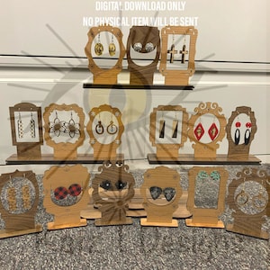 May include: Wooden earring display stands with various styles and designs. Each stand features a cutout shape and holds a pair of earrings. The stands are arranged in three rows on a wooden surface.  DIGITAL DOWNLOAD ONLY. NO PHYSICAL ITEM WILL BE SENT.