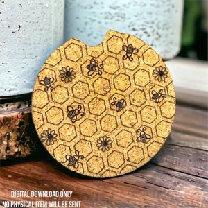 May include: A round cork coaster with a honeycomb pattern and bees. The coaster is yellow and brown with black bees.