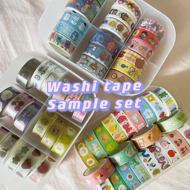 May include: A collection of decorative washi tape rolls in a sample set. The tapes feature various colorful designs, including cartoon characters, food items, and floral patterns. The text "Washi tape Sample set" is visible.
