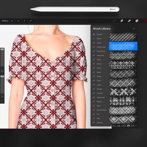 May include: A red and white patterned dress with a V-neck and short sleeves. The dress has a button closure at the front. The pattern is a repeating geometric design.