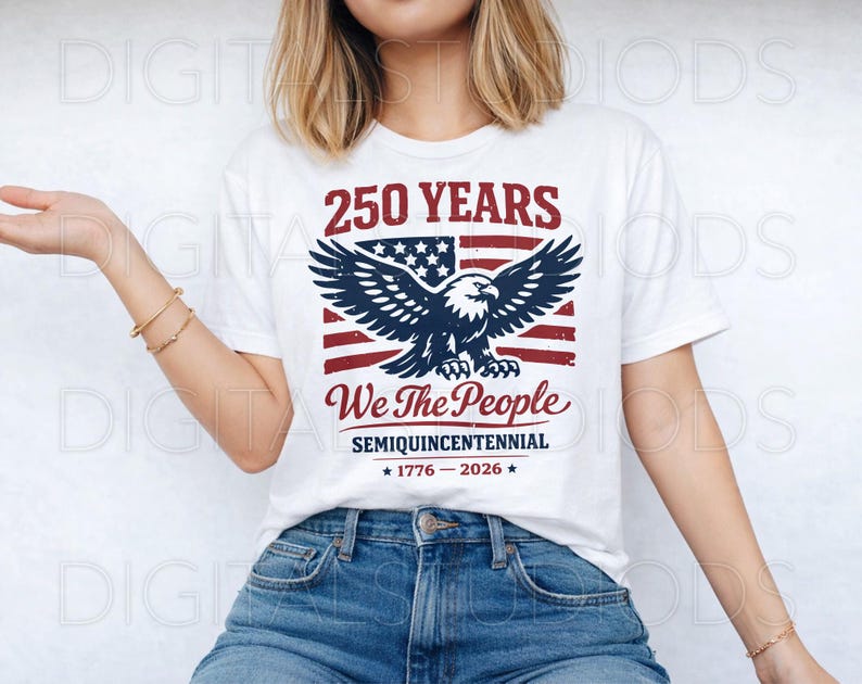 May include: White t-shirt with a patriotic design. The graphic features an American flag, an eagle, and the text "250 YEARS We The People SEMIQUINCENTENNIAL 1776-2026". The shirt is worn with blue jeans.