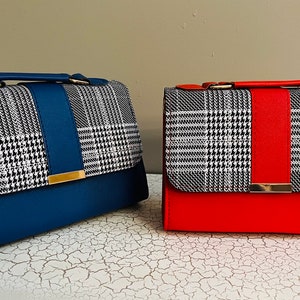 May include: Two small handbags with a plaid pattern on the flap and a solid colored bottom. The handbag on the left is blue and the handbag on the right is red.