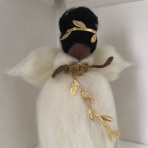 African American Angel tree topper in wool with white and golden dress.