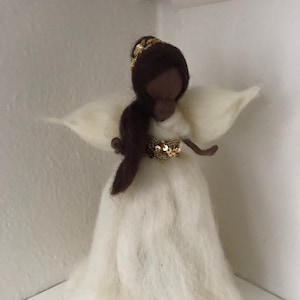 African American Angel tree topper in wool with white and golden dress.