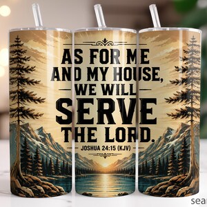 May include: A stainless steel tumbler with a straw, featuring a scenic landscape design with mountains, trees, and a lake. The tumbler has the text "AS FOR ME AND MY HOUSE, WE WILL SERVE THE LORD." Joshua 24:15 (KJV).