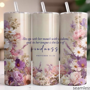 May include: A set of three stainless steel tumblers with floral designs in pink, purple, and white. The tumblers feature a straw and the text "She openeth her mouth with wisdom; and in her tongue is the law of kindness" and "PROVERBS 31:26".