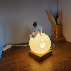 Astronaut Sitting on Moon Decorative Night Light | Astronaut Moon LED Bedside Lamp | Space & Astronomy Lover Tabletop Light