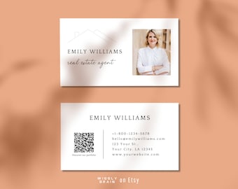 May include: White business card with black text for Emily Williams, a real estate agent. The card includes a house icon, a headshot of Emily Williams, contact information, and a QR code. The text on the card reads "Emily Williams, real estate agent, +1-800-1234-5678, hello@emilywilliams.com, 123 Your St., Your City, LA 12345, www.yourwebsite.com, Discover our portfolio, Wiggly Brain on Etsy".