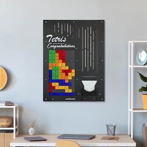 May include: A black framed wall art piece with the words "Tetris Congratulations" in white lettering. The art piece features a colorful Tetris game board with a variety of colored blocks.