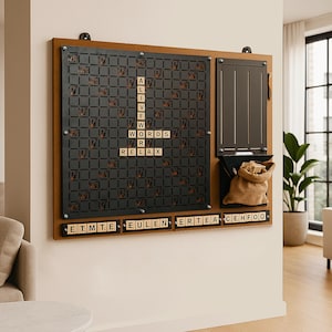 May include: A wooden Scrabble board mounted on a wall, featuring a black grid and wooden letter tiles spelling "ALIVE", "WORDS", and "RELAX". Includes a storage area with a small burlap bag and a compartment for tiles. The board is brown with black accents.