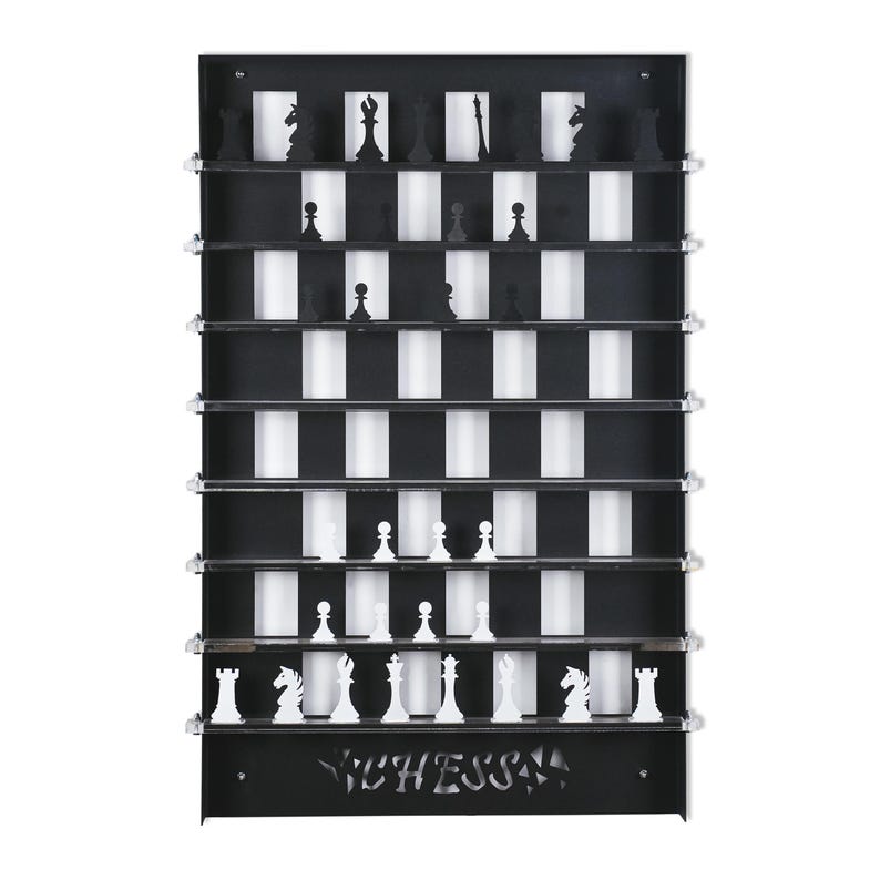 May include: A black wooden chessboard with white squares and black squares. The chessboard is mounted on a wall and has a shelf for each row of the board. The chess pieces are black and white and are arranged on the board in a starting position. The word "CHESS" is cut out of the bottom of the board.