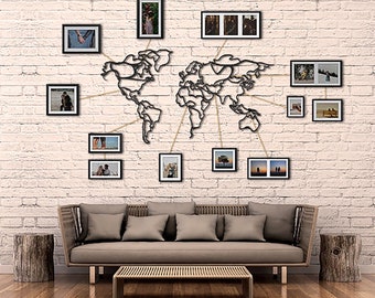 May include: A black metal world map wall decor with string connecting various black picture frames with photos of a couple. The frames are arranged around the map on a white brick wall.