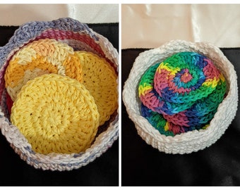 May include: Two crocheted baskets filled with colourful crocheted circles. The basket on the left is grey and pink with yellow, orange, and pink circles. The basket on the right is white with multi-coloured circles.
