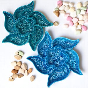 May include: Two blue ceramic serving dishes with intricate floral designs. Each dish has five sections, perfect for serving snacks or appetizers.